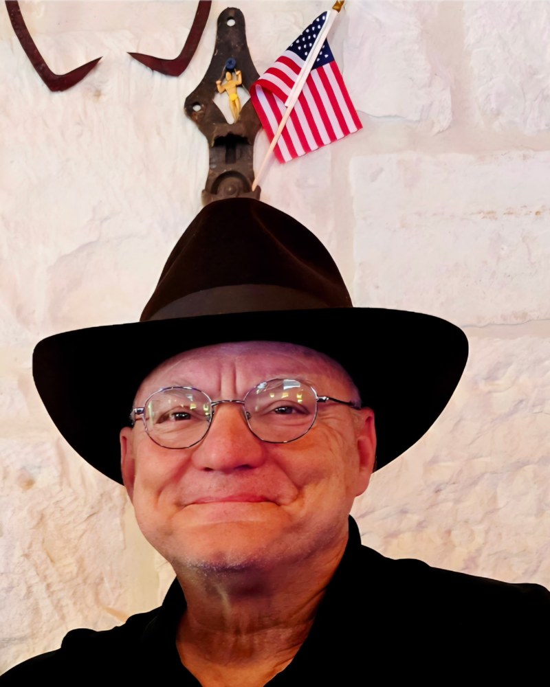 Wesley Tarpley smiling in a black hat and glasses